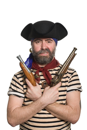 Bearded pirate in tricorn hat with a muskets